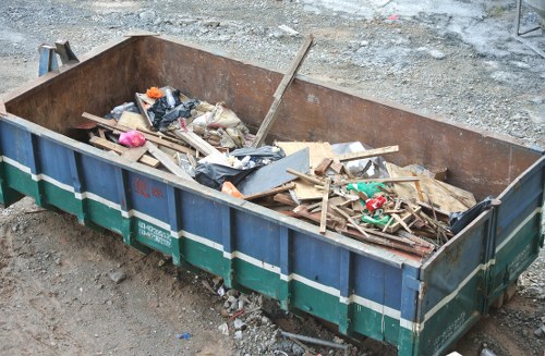 Safety supervisor checking insurance documents at a commercial waste site in Turnham Green